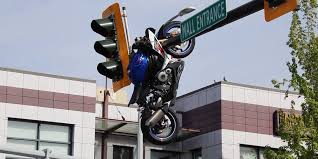Motorcycle left hanging off traffic light after crash