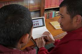 Jampa Tenzin checks this blog on the mini computer, to see the picture and bio-data of Dorje Wangchuk, our newest monk. - back_view1