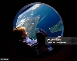 Image of family looking out the window of a spaceship at the Earth