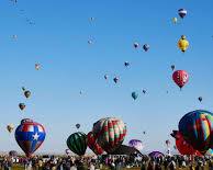 Image of hot air balloons dotting a colorful New Mexico sky during a festival