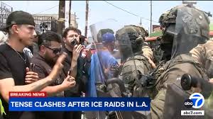 Hundreds of protesters rally outside federal building to condemn ICE raids