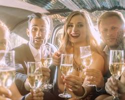 Image of group of friends toasting champagne inside a limo