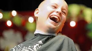 Ryan Tarr, 11, laughs at his classmate after seeing his bald head at Friday?s fundraising event. - Ryan-Tarr