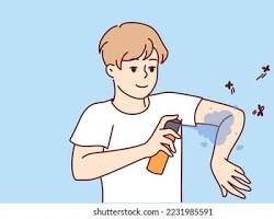 Obraz: person applying insect repellent
