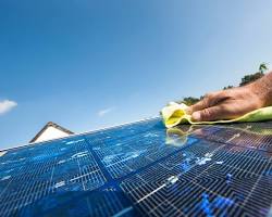 Image of cleaning solar panels with soapy water and sponge