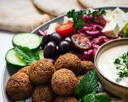 Falafel served with pita bread, hummus, and tahini sauce