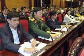 Vietnam's National Assembly's deputies press voting buttons to pass the new constitution during a meeting in Hanoi