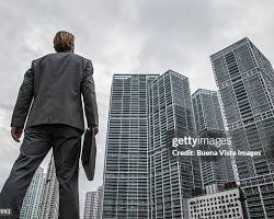 Image of person looking up at a skyscraper