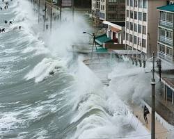 Image of tsunami wave crashing into a coastal area