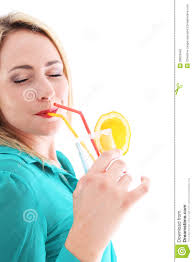 Blissful woman drinking orange cocktail - blissful-woman-drinking-orange-cocktail-26603442