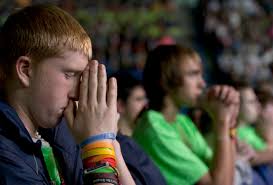 Dan Raftis, 15, from St. Patrick Church in Owego, N.Y., prays after receiving Communion during the closing Mass of the National Catholic Youth Conference ... - catholic-youth3