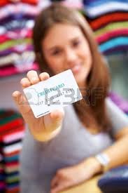 woman holding a credit card in a shop - please note the creditcard numbers are made up - 2630040-woman-holding-a-credit-card-in-a-shop--please-note-the-creditcard-numbers-are-made-up