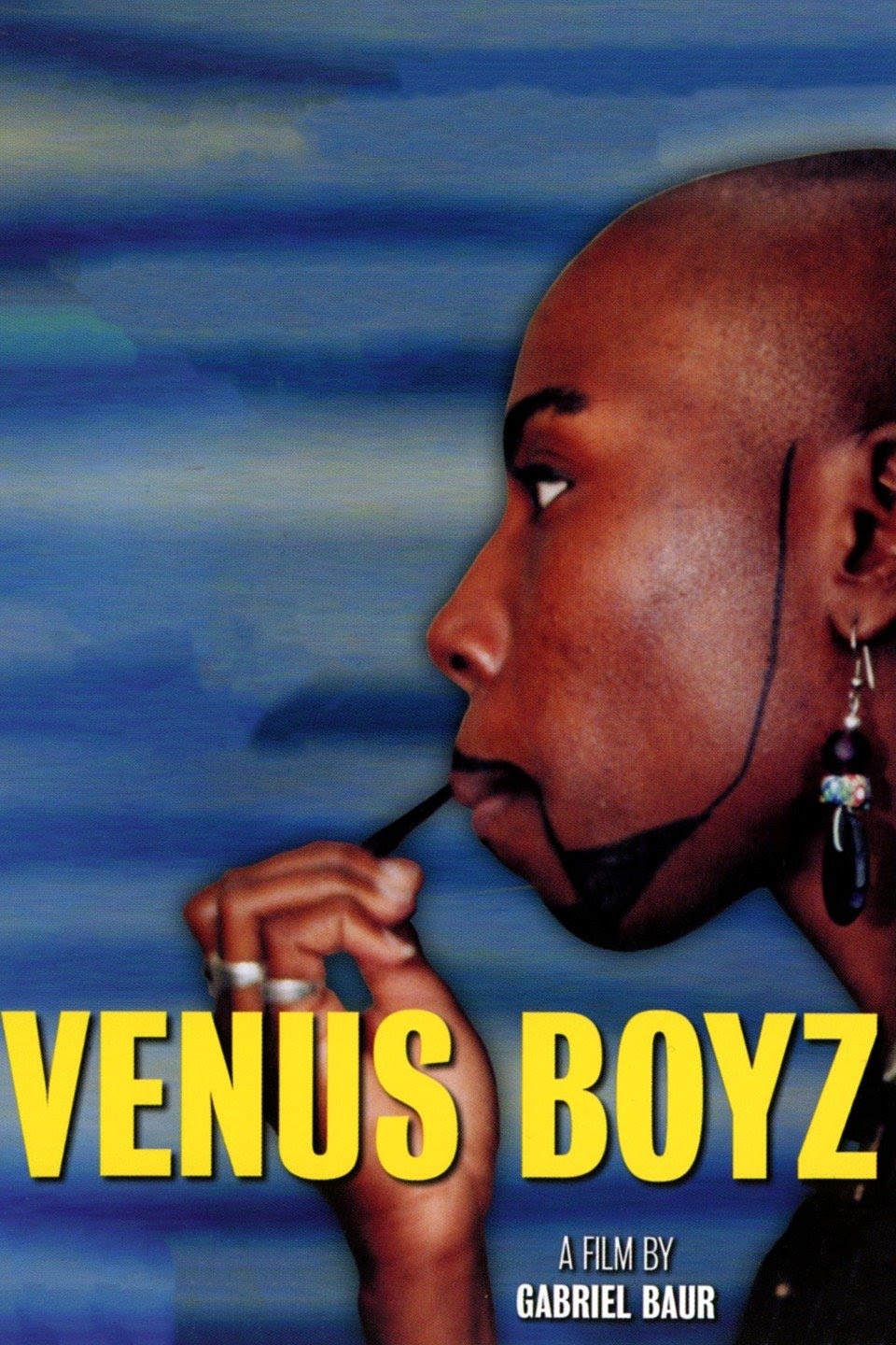 A drag king painting on his beard in a movie poster for Venus Boyz
