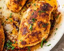 Image of Searing chicken in a skillet