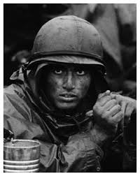 Closeup portrait of a Marine&#39;s face, which is covered in dirt from the battlefield. Marine in trench at Con Thien. David Douglas Duncan. Vietnam, 1967. - ddd01