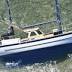 Solo yachtsman runs aground on reef during around the world attempt