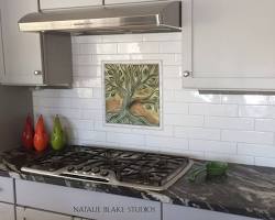 Porcelain tile backsplash in white kitchen