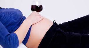 Pregnant Woman With Wine Glass On Stomach