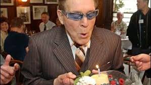 Health and fitness expert Jack LaLanne blows out a birthday cake at his 90th birthday party in a San Francisco file photo from Oct. 16, 2004. - image651222x