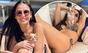 "Age-defying Demi Moore stuns in leopard print bikini with adorable pet Pilaf"