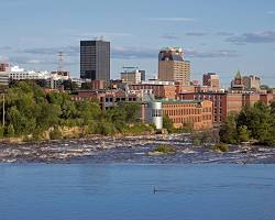 Image of Manchester, New Hampshire skyline with the Merrimack River in the foreground