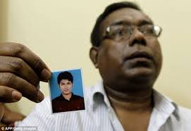 &#39;He can&#39;t do it&#39;: Quazi Mohammad Ahsanullah, the father of Quazi Nafis, holds a portrait of his son in Dhaka - article-2219551-158FD4C0000005DC-447_634x437