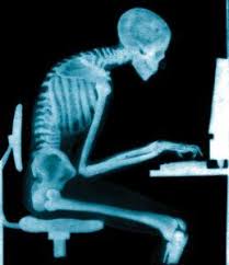 X-ray image of person slumping at a computer station