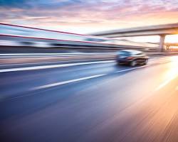 Image of car speeding down a highway
